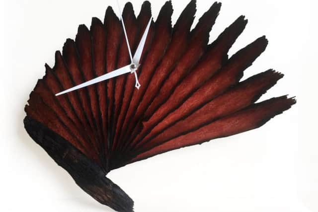 An art deco fan clock carved from the pier's Ekki wood