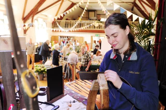 Saddler Kelly Jones from Midhurst demonstrating her skills at the Easter Market Picture by Kate Shemilt ks170820-4