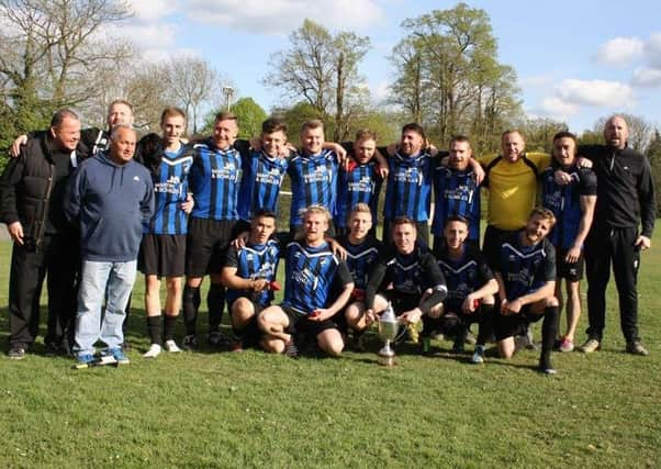 Hollington United celebrate winning the Macron East Sussex Football League Premier Division title.