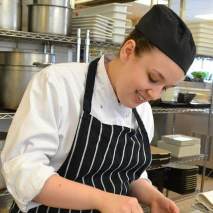 Chef Monica Bance putting the finishing touches to the dish