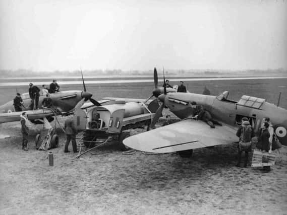 Max Aitken, left, watches as his No. 601 Squadron Hurricane is refuelled at Tangmere during the Battle of Britain.