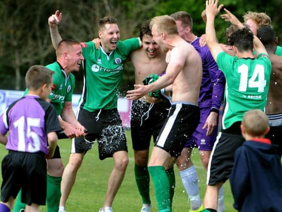 Players celebrate after the Merstham game. Picture by Steve Robards