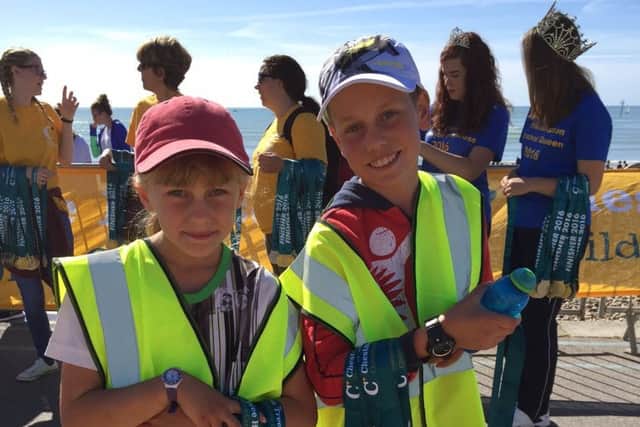 George and his sister Millie handing out medals at Littlehampton 10k