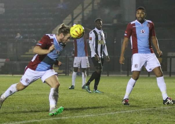 Matt Bodkin, pictured here scoring a header against Tooting & Mitcham United, and Jack Harris (background) are among the six players Hastings United have exercised contract options to retain for next season. Picture courtesy Scott White