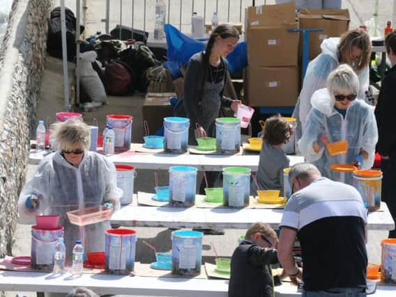 Artists pick their chosen colour to add to the beach canvas (Photograph: Eddie Mitchell)