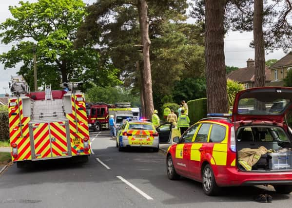 Firefighters and ambulance crew worked to rescue a woman trapped after a collision. Pictures: Nick Fontana