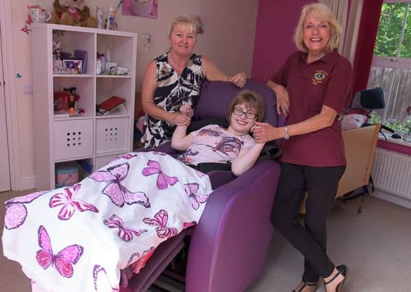 Charlotte in her Porta Chair funded by Bexhill Lions Club, mum Julie,  and Lion June Hough SUS-170613-114236001