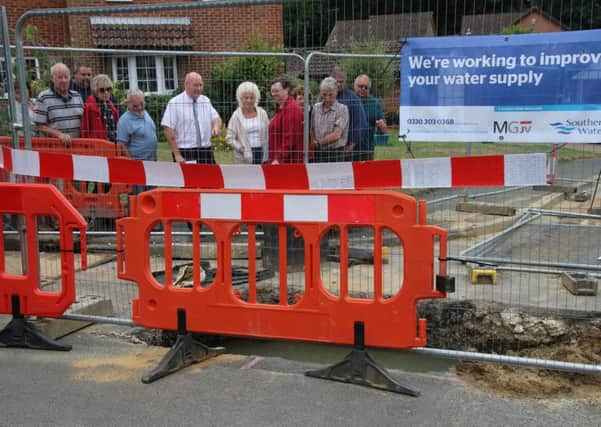 Cllr Scott with unhappy residents by one of the trenches in Arbourvale. Picture by Alan Roberts