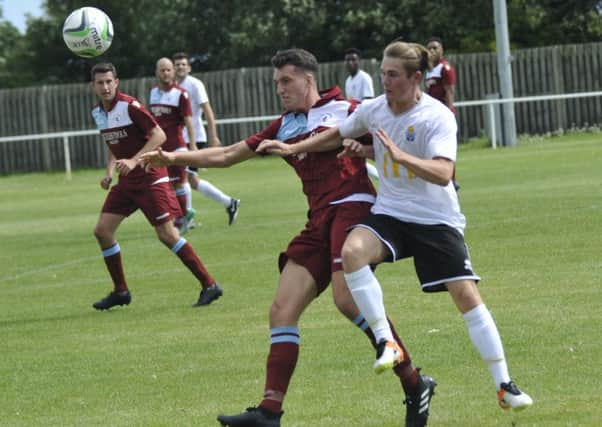 Little Common debutant Liam Ward tussles with Kane Penn, scorer of Eastbourne United's equaliser. Pictures by Simon Newstead