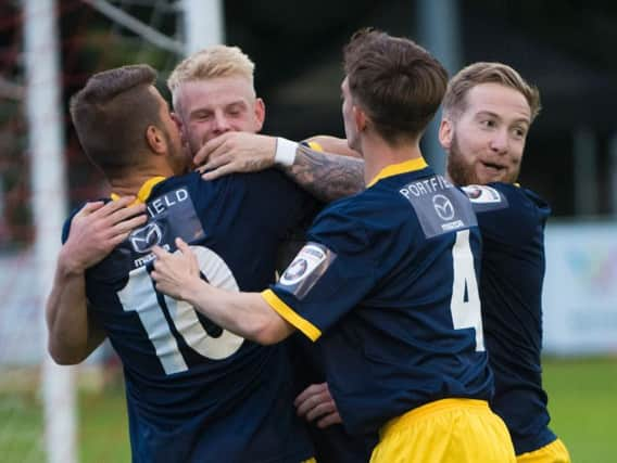 Corey Heath is congratulated after opening the scoring at Poole / Picture by Tommy McMillan