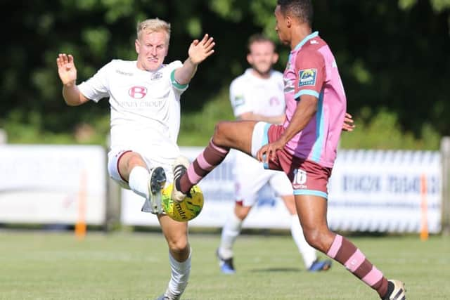 Hastings captain Simon Johnson competes for a bouncing ball with Corinthian-Casuals substitute Daniel Cunningham. Picture courtesy Scott White