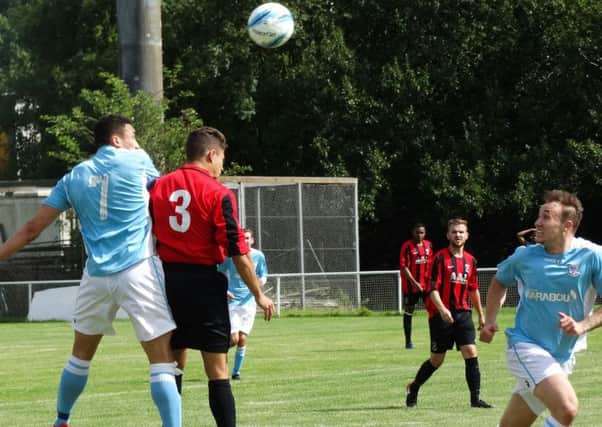 Ashley Kidman gets up highest during Bexhill United's 7-0 win away to Oakwood on Saturday. Picture courtesy Mark Killy