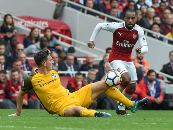 Lewis Dunk challenges Arsenal striker Alexandre Lacazette. Picture by Phil Westlake (PW Sporting Photography)