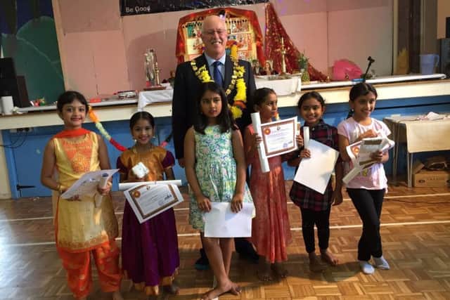 Chichester mayor Peter Evans presents certificates and gifts to the children