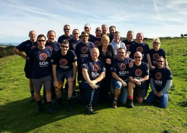 The SGN team (L-R: Richard Mendham, Glenn Norman, Drew Reynolds, Wayne Edwards, Paul Rose, Andy Scott, Paul James,  Richard Murray, Gavin Brown, Peter Webster, Steve Catling, Maria Fairchild, Iain Fourniss ,Graham Cox, Tracey McIntyre, Rob Instrall and (kneeling) Mark Meloy, Steve Mills, Simon Russell and Steve Harger) take a break from their hard work at Cissbury Ring