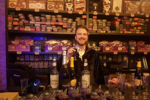 Oliver Dall behind the counter at his new wizarding shop in Brighton