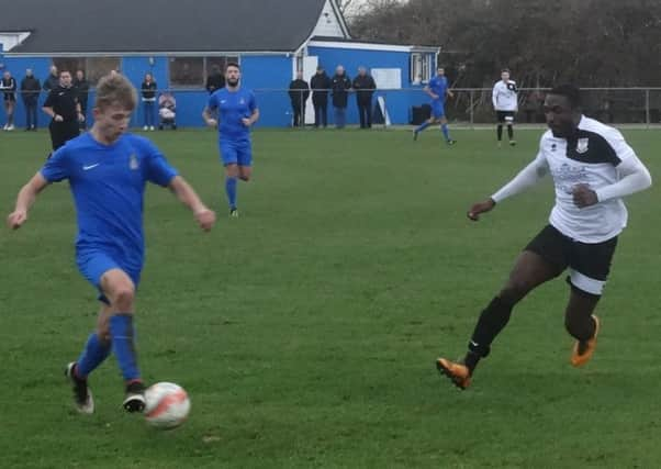 Bexhill United wide player Georges Gouet closes down a Selsey opponent. Picture courtesy Mark Killy